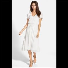 Lightweight V-Neck Midi Dress With A Blouson Waist Brings Feminine Style And Versatility To Your Wardrobe. V-Neck Short Sleeves Slips On Over Head Elasticized Blouson Waist White Flowy V-neck Dress For Brunch, White V-neck Dress For Spring Daywear, Knee-length White V-neck Dress For Day Out, Flowy White V-neck Dress For Brunch, White Knee-length V-neck Dress For Day Out, White Short Sleeve V-neck Dress For Brunch, Chic White V-neck Dress For Daywear, Casual White Midi Dress With V-neck, Chic White Flowy V-neck Dress