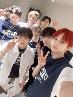 group of young men posing for the camera with their hands up in front of them