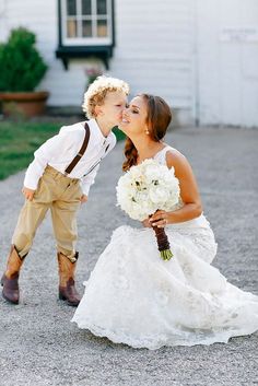 a young boy kissing his bride on the cheek