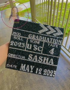 someone holding up a black and white graduation cap with the words, congratulations on it