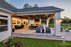 an outdoor living area with patio furniture and lighting