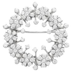 A stunning, fine and impressive vintage Italian 2.78 carat diamond and 18 carat white gold brooch; part of our vintage jewellery collections. This stunning, fine and impressive vintage diamond brooch has been crafted in 18ct white gold. The floriated wreath design is ornamented with ten flower-head cluster tremblant settings; this setting style indicates the high quality of the piece. Each flower head design is embellished with seven transitional modern brilliant round cut diamonds. The brooch i Luxury White Gold Ornate Brooches, Luxury Fine Jewelry Round Brooches, Luxury Vintage Diamond White Jewelry, Luxury Brilliant Cut Diamond White Brooches, Luxury Diamond White Brilliant Cut Brooches, Luxury White Diamond Brooches, Luxury White Gold Platinum Brooch, Luxury White Gold Brooches, Luxury Fine Jewelry Brooches In White Gold