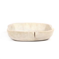 a white wooden bowl sitting on top of a table