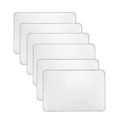 five white plastic place mats on a white background