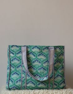 "cotton quilted  Jhola Bag made by Indian Artisans, this cotton quilted shopping bag is totally unique and multi purpose. Use this for your grocery or as a travel bag. Perfect to suit all. Size in Inch:- Height-19\" inch Width- 25\" inch Handle-11\" inch Size In CM:- 40x40x13 cm Handle height- 35 cm Material: 100% Cotton Pattern: Quilted Style: Ethnic Product Work: Printed & quilted Stitched Usage : Cosmetic, Make-up, Travel, Toiletries, Medicine, Accessories, Shopping and much more. Perfect for Beach Visits/ Quick Grocery runs/ Carrying Kids items/ Artist Paint book and Paints /Extra Bag Washable on Cold / Delicate wash Make a good Sustainable Gift . Wash Care Instructions:- Dry clean only" Green Quilted Square Bag, Square Green Quilted Bag, Green Rectangular Cotton Bags, Green Quilted Bag For Daily Use, Green Reversible Cotton Shoulder Bag, Green Quilted Rectangular Bag, Green Handmade Cotton Canvas Bag, Handmade Green Cotton Canvas Bag, Travel Quilted Cotton Shoulder Bag