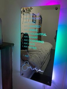 there is a mirror with the words i am sorry on it in front of a bed