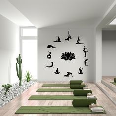 there are many yoga mats lined up in the room with wall decals on it