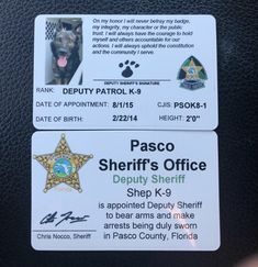 two id badges on the back of a vehicle with a dog's face and name