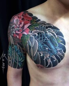 a man's chest covered in tattoos and flowers