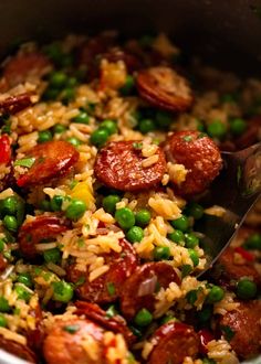 a pot filled with rice, peas and sausage