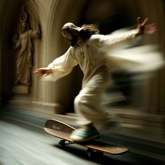 a man riding a skateboard on top of a wooden floor