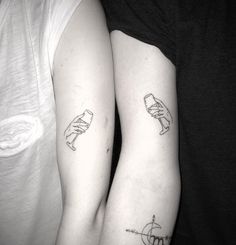 two people with matching tattoos on their arms