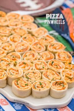 a platter filled with mini pizzas on top of a blue and white table cloth