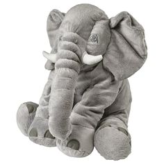 an elephant stuffed animal sitting up against a white background