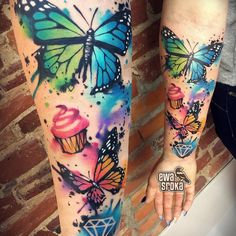 two women with tattoos on their arms and legs, both have colorful butterflies flying over them