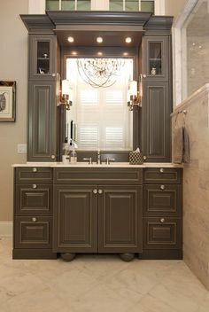 a bathroom with a double sink and large mirror over it's vanity area, along with a chandelier hanging from the ceiling