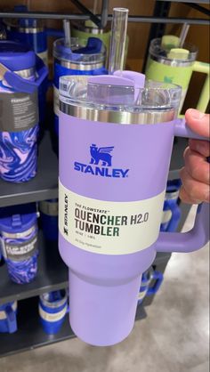 the tumbler cup is purple and has a straw in it