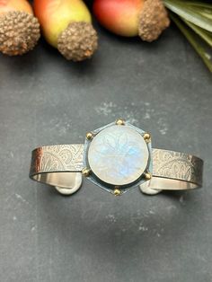 "This. Cuff. Is. AMAZING!  This cuff features a beautifully carved and  flashy Rainbow Moonstone set in fine silver, sterling silver and 22k gold accent dots.   The cuff band is 3/8\" wide with an interior measurement of  6\" inches with an opening of  1 1/8\".  This bracelet will fit a wrist size of 7\" to a 7 1/2\"" Gold Wrist Cuff, Gold Accent, Mixed Metals, 22k Gold, Fine Silver, Rainbow Moonstone, Sterling Silber, Gold Accents, Moonstone