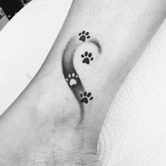 a black and white photo of a foot with paw prints on it's side