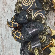 a close up of a black and gold wreath