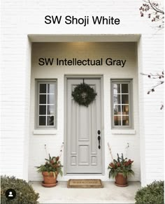 a white door with two potted plants in front of it and the words sw intelectual gray written below