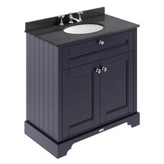 a bathroom vanity with a white sink and black cabinet