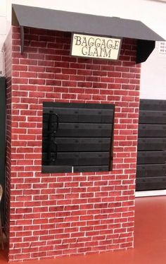 a small brick building with a sign on the door that says baggage claim