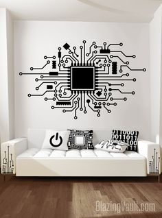 a living room with a white couch and a black computer circuit board wall decal