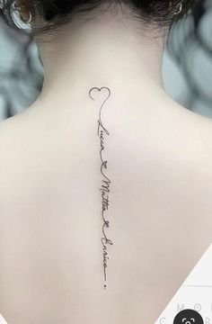 the back of a woman's neck with an inscription on it that says, i love