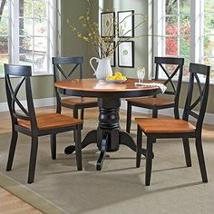 a dining room table with four chairs around it