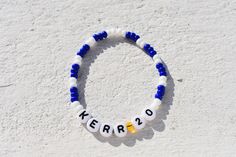 Introducing our stunning Handmade Chelsea Women's Team Colors Bead Bracelet - the perfect accessory for any passionate Chelsea FC fan! Show your unwavering support for the Blues in style with this customizable bracelet that lets you wear your team pride on your wrist. 🔵 Features: - Handcrafted with love and care, this bracelet showcases the iconic Chelsea Women's Team Colors - the vibrant blues and white that signify excellence and dedication. - Personalize your bracelet by adding your favorite Chelsea Women's player's name and jersey number. It's a fantastic way to celebrate your sporting heroes or even commemorate your own love for the game! - Each bead is expertly chosen to represent the team's spirit, making it an exceptional keepsake for Chelsea fans. 🔵 The Perfect Gift: This Chelse Personalized Blue Bracelets For Game Day, Blue Team Spirit Beaded Bracelets As Gift, Personalized Blue Bracelets For Sports Events, Blue Beaded Bracelets For Team Spirit Gift, Blue Beaded Bracelets With Letter Beads For Team Spirit, Personalized White Wristband For Team Events, Personalized White Wristbands For Team Events, Customizable White Wristband For Everyday, Personalized White Wristband Team Spirit