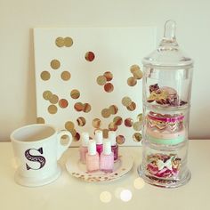 a white table topped with lots of confetti next to a cup and saucer