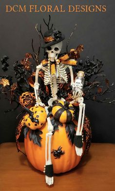 a halloween decoration with skeletons and pumpkins