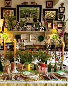 a dining room table with plates and flowers in vases on it's centerpiece