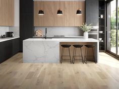 a modern kitchen with marble counter tops and wooden cabinets, along with bar stools