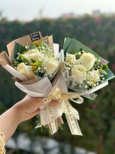 a bouquet of flowers being held by someone's hand