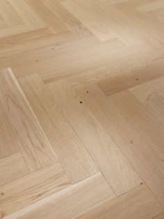 an image of wood flooring that looks like herringbones