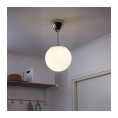 a white light hanging from the ceiling in a kitchen