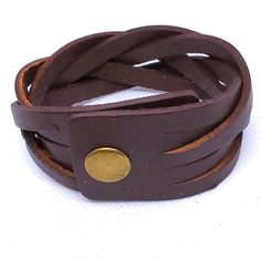 Add A Touch Of Punk, Bohemian, And Western Style To Your Outfit With This Brown Braided Faux Leather Snap Cuff Bracelet. Measuring 8.5 Inches In Length, This Cuff Bracelet Is Perfect For Any Occasion And Is Adjustable For Comfortable Wear. The Metal Snap Closure Ensures That The Bracelet Stays Securely In Place, While Providing Durability. This Bracelet Features A Unique Design That Is Both Stylish And Versatile. With No Stones And A Rectangular Shape, It Is A Perfect Addition To Any Jewelry Col Brown Leather Punk Style Jewelry, Punk Style Brown Leather Jewelry, Adjustable Leather Punk Cuff Bracelet, Adjustable Brown Punk Bracelets, Brown Punk Leather Bracelet For Gift, Brown Cuff Leather Bracelet, Brown Leather Cuff Bracelet, Handmade Punk Leather Bracelet, Handmade Leather Punk Bracelet