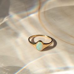 Meet your new favorite statement ring - the Opal Signet Ring. With just the right amount of sparkle and flash, this Australian opal ring makes a gorgeous statement by itself - or paired with your favorite stacked rings. It's made of 14k solid gold, so it'll last many lifetimes. After you're done with it, you can pass it on as an heirloom! DETAILS 14k solid gold ring 5mm x 7mm Australian opal Available in sizes 5-8 Weight: 1.5g Safe for sensitive skin & shower safe Matching jewelry: Oval Opal Nec Inlaid Opal Ring, Antique Opal Ring Vintage, Opal Signet Ring, Opal Engagement Ring Silver, Vintage Opal Rings, Gold Opal Rings, Opal Ring Simple, Antique Opal Ring, Oval Opal Ring