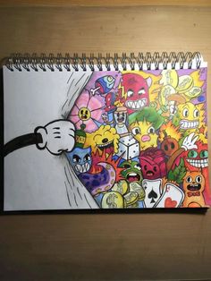 a spiral notebook with cartoon characters drawn on it