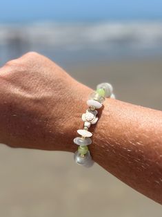 Embrace the spirit of the sea with the Mira Sea Turtle stretch bracelet. Crafted with care, this bracelet boasts a symphony of recycled-glass beads, Jade beads, and Czech-glass beads that simultaneously evoke the sparkle and calming hues of the sea. Gold-plated hematite adds a little shine, and the single sea turtle bead pays homage to the gentle guardians of the ocean. She measures about 7.5 inches. Whether you’re strolling along the shore or simply seeking a touch of tranquility in your daily Adjustable Czech Glass Bracelets For Beach, Beach Glass Jewelry Hand-strung, Beaded Glass Bracelets For Beach, Beaded Czech Glass Bracelets For The Beach, Spiritual Beaded Stretch Bracelet For Beach, Colorful Glass Bead Bracelets For Beach, Colorful Glass Beaded Bracelets For Beach, Beach Bracelets With Colorful Glass Beads, Glass Bracelets With Colorful Beads For Beach