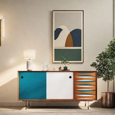 a living room scene with focus on the sideboard and plant in vases against the wall