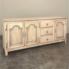 a large white wooden cabinet sitting on top of a floor