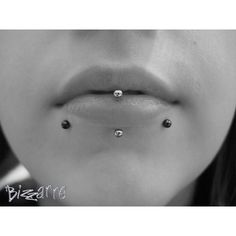 a woman with three piercings on her nose