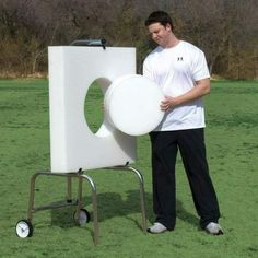 a man standing next to a large white object