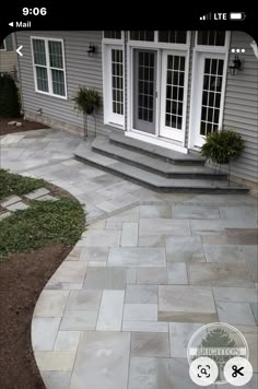 an outdoor patio with steps leading to the front door