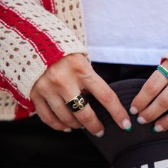 Our Black Nickelmark Cigar Ring is perfect for adding a bold statement to your jewelry box. It features black enamel paired with our signature Nickelmark design embedded with cubic zirconia, and plated with 2.5 microns of 14k gold over sterling silver. Make a statement with this N&S branded logo ring. *Fits small, recommended to size up for best fit Nickel And Suede, Signature Design, Gold Design, Black Enamel, Cigars, Gold Style, Band Rings, Brand Logo, Jewelry Box