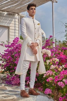 White sherwani with textured pattern. Paired with churidar. - Aza Fashions Designer Sherwani With Dupatta For Reception, Designer Wedding Kurta With Dupatta, Designer Straight Kurta Sherwani For Wedding, Elegant White Chanderi Sherwani, Ceremonial White Cotton Sherwani, Fitted White Sherwani With Cutdana Details, Transitional Ceremonial Off-white Sherwani, White Semi-stitched Chanderi Sherwani, Model Outfit