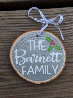 a christmas ornament with the words, the barnett family on it hanging from a wood slice